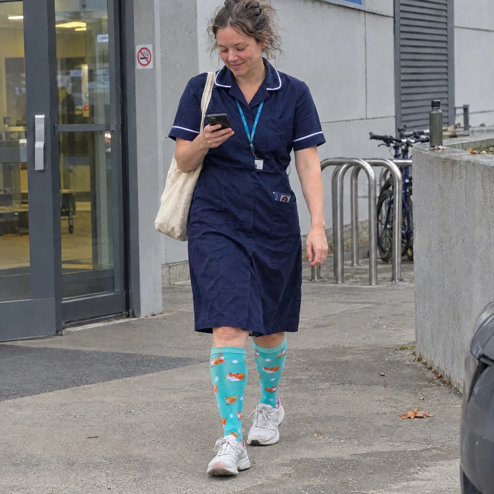 Nurse wearing TheraWear Sleepy Fox knee-high socks